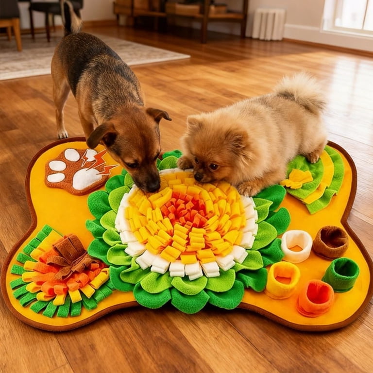 Two dogs sniffing and foraging on colorful bone-shaped snuffle mat on wooden floor