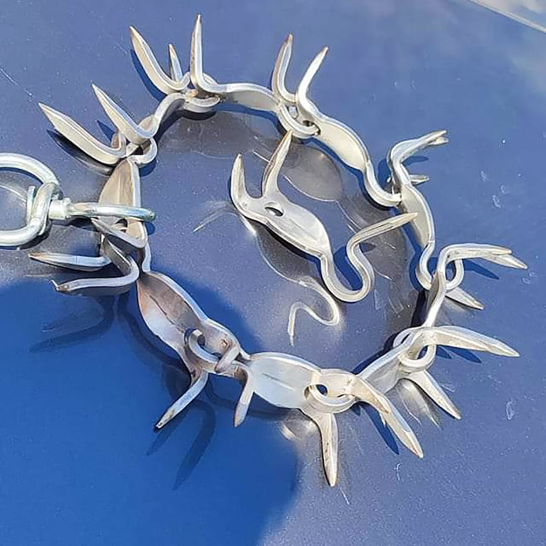 Spiked metal dog collar on a blue surface