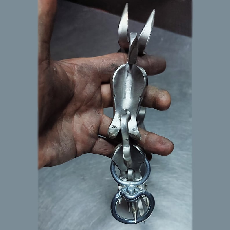 Spiked collar links held in a hand